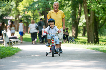 Image showing grandfather and child have fun  in park