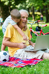 Image showing grandfather and child using laptop