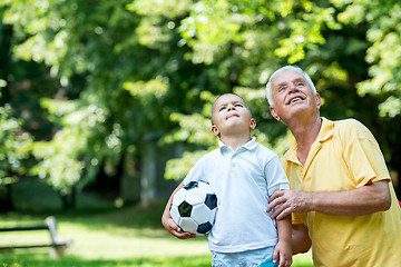 Image showing grandfather and child have fun  in park