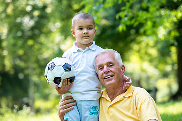 Image showing grandfather and child have fun  in park