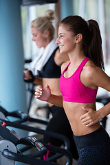 Image showing lifting some weights and working on her biceps in a gym