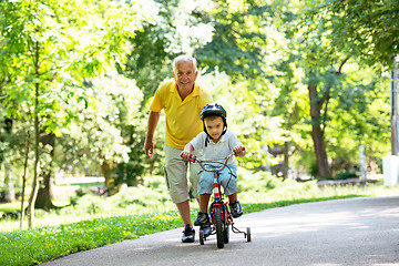 Image showing grandfather and child have fun  in park