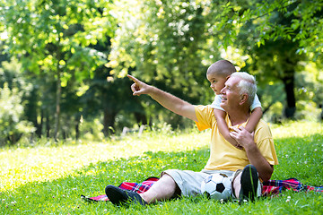 Image showing grandfather and child have fun  in park