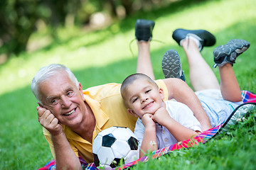 Image showing grandfather and child have fun  in park