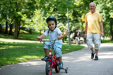 Image showing grandfather and child have fun  in park