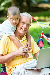 Image showing grandfather and child using laptop