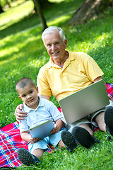 Image showing grandfather and child using laptop