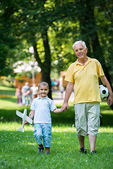 Image showing grandfather and child have fun  in park