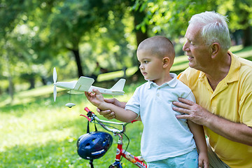 Image showing grandfather and child have fun  in park