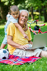 Image showing grandfather and child using laptop