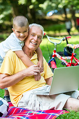 Image showing grandfather and child using laptop