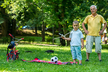 Image showing grandfather and child have fun  in park