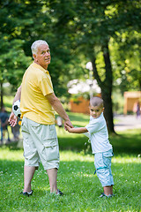 Image showing grandfather and child have fun  in park