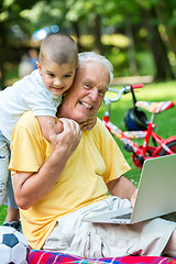 Image showing grandfather and child using laptop