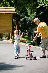 Image showing grandfather and child have fun  in park