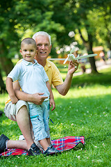 Image showing grandfather and child have fun  in park