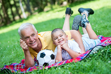 Image showing grandfather and child have fun  in park