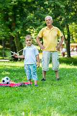 Image showing grandfather and child have fun  in park