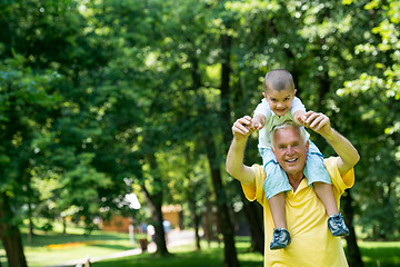 Image showing grandfather and child have fun  in park