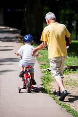 Image showing grandfather and child have fun  in park