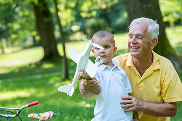 Image showing grandfather and child have fun  in park