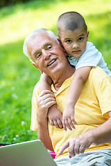 Image showing grandfather and child using laptop