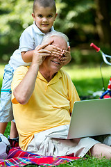 Image showing grandfather and child using laptop