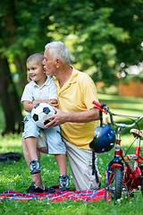 Image showing grandfather and child have fun  in park