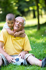 Image showing grandfather and child have fun  in park