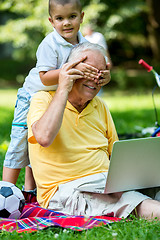 Image showing grandfather and child using laptop