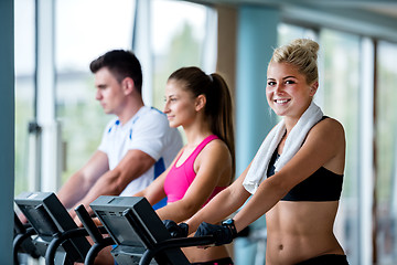 Image showing friends  exercising on a treadmill at the bright modern gym