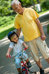 Image showing grandfather and child have fun  in park