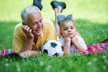 Image showing grandfather and child have fun  in park