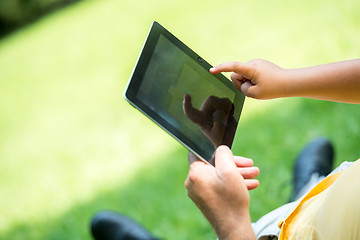 Image showing grandfather and child in park using tablet