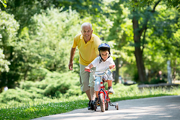 Image showing grandfather and child have fun  in park