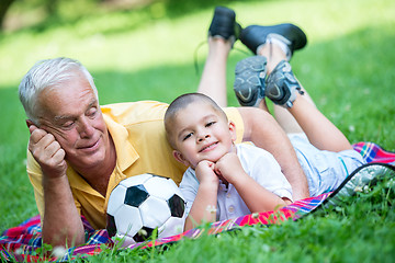 Image showing grandfather and child have fun  in park