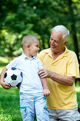 Image showing grandfather and child using laptop