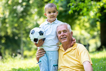 Image showing grandfather and child have fun  in park