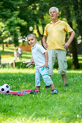 Image showing grandfather and child have fun  in park