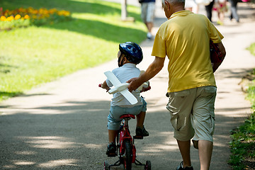 Image showing grandfather and child have fun  in park