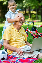 Image showing grandfather and child using laptop