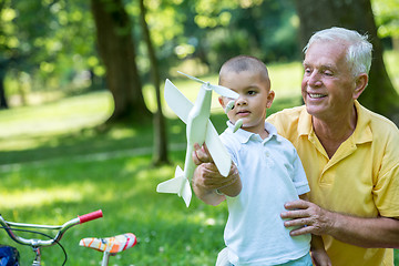 Image showing grandfather and child have fun  in park