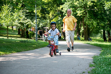 Image showing grandfather and child have fun  in park