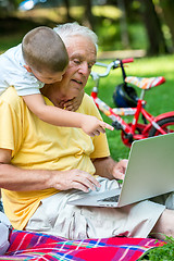 Image showing grandfather and child using laptop