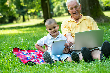 Image showing grandfather and child using laptop