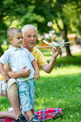 Image showing grandfather and child have fun  in park