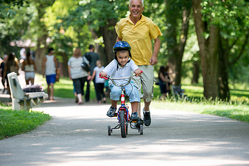 Image showing grandfather and child have fun  in park