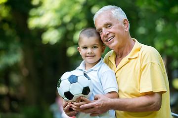 Image showing grandfather and child have fun  in park