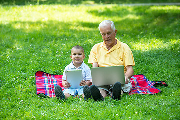 Image showing grandfather and child using laptop