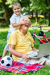 Image showing grandfather and child using laptop